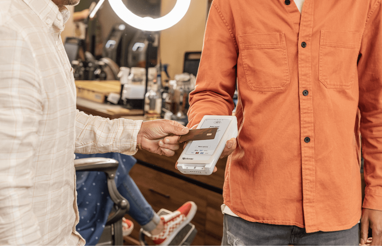 Product shot showing a customer making a payment on the Clover Flex Smart Terminal