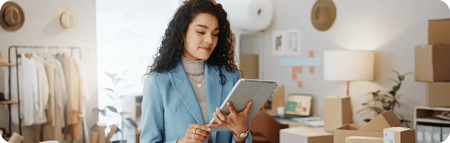 Woman in blazer happily tracking and monitoring recurring payments on a tablet