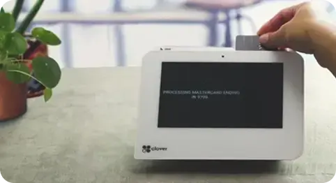 Customer making a payment using the Clover Mini POS machine