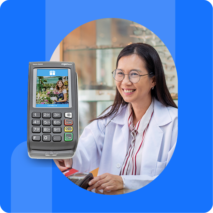 Woman in glasses making a payment using the Desk/5000 countertop debit machine